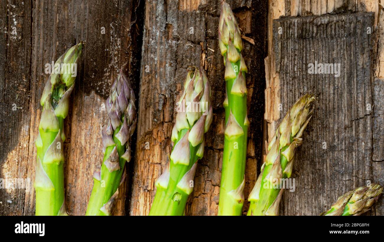 Bunch of fresh green asparagus spears rich in vitamin, glutathione,  minerals, on old rustic wooden background Stock Photo - Alamy