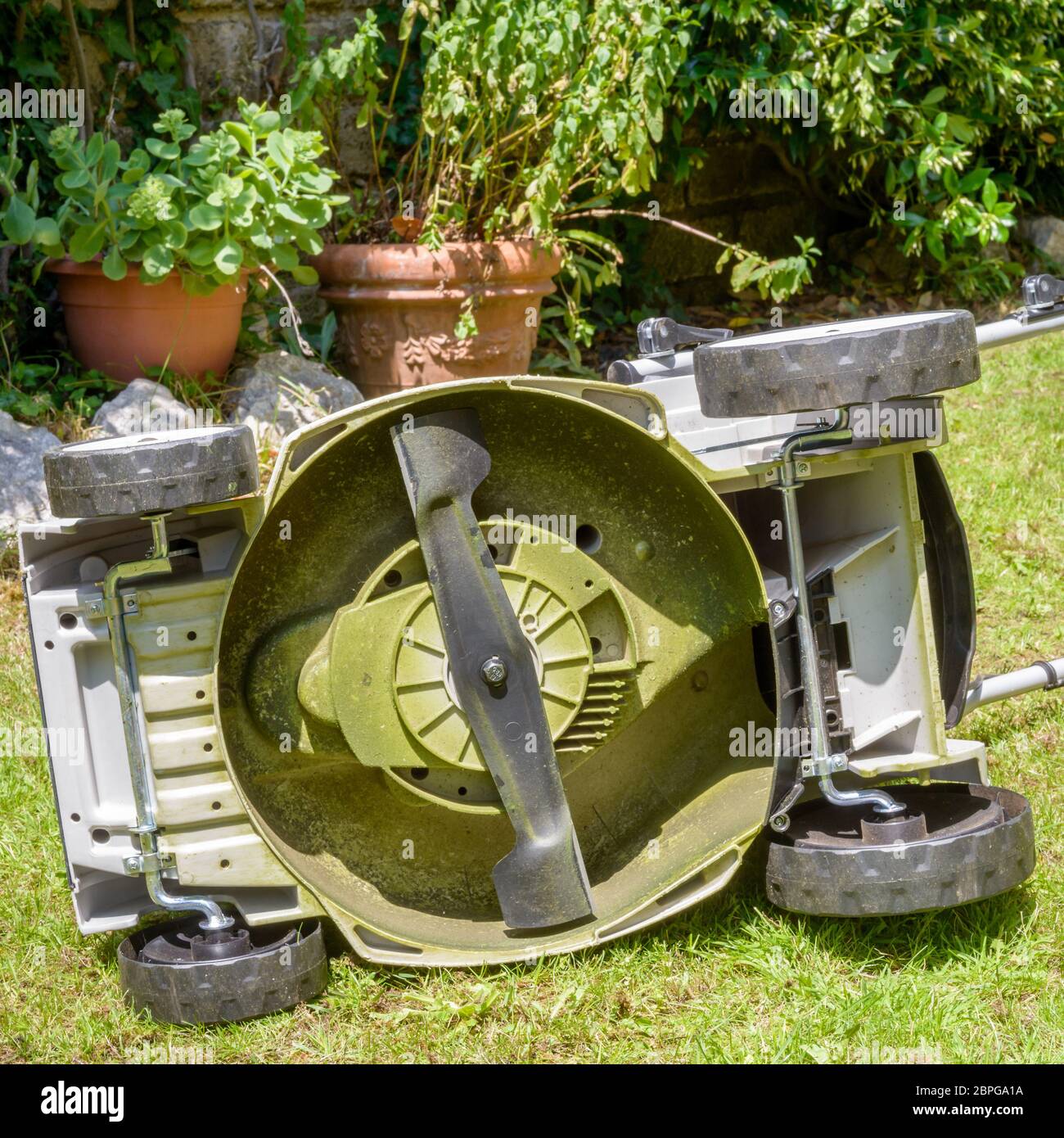 Rotating blades in the bottom of a Lawnmower Stock Photo Alamy