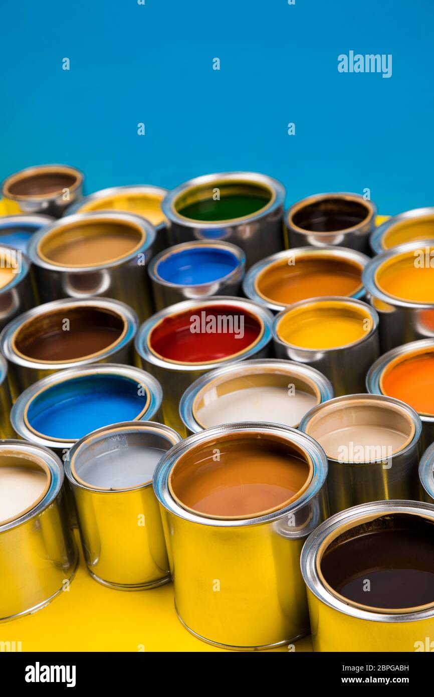 Open cans of paint, blue background Stock Photo Alamy