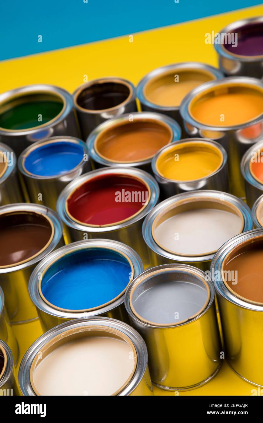 Open cans of paint, blue background Stock Photo Alamy
