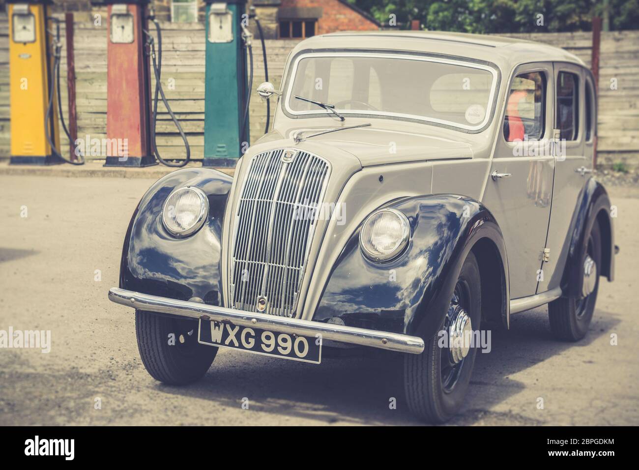Retro, front view close up of classic vintage Morris 8 motor car parked outside vintage garage, UK. Stock Photo