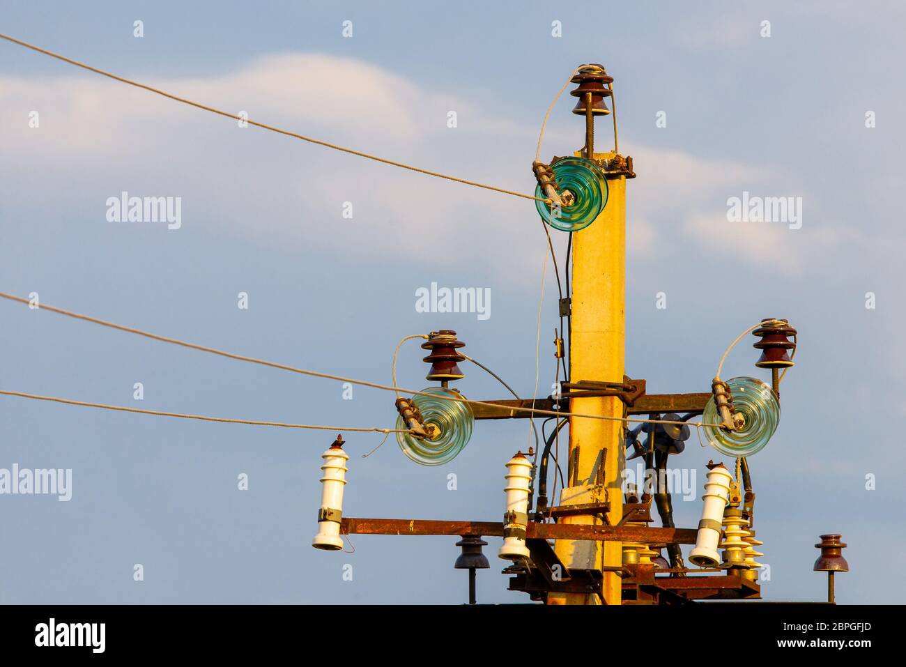 Close up of high voltage insulators with aluminium wire at power-tower ...
