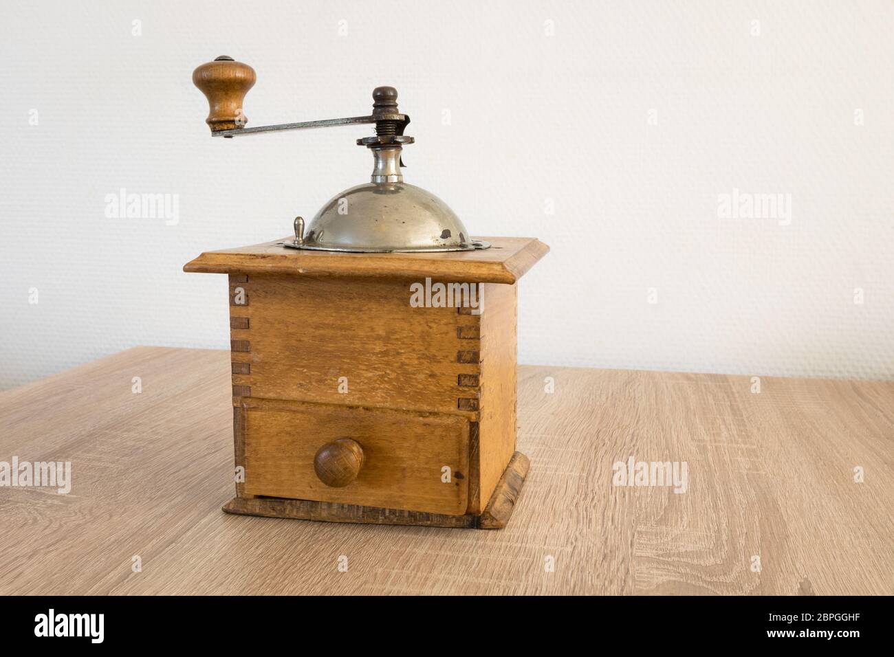 Ancient coffee grinder on a table Stock Photo