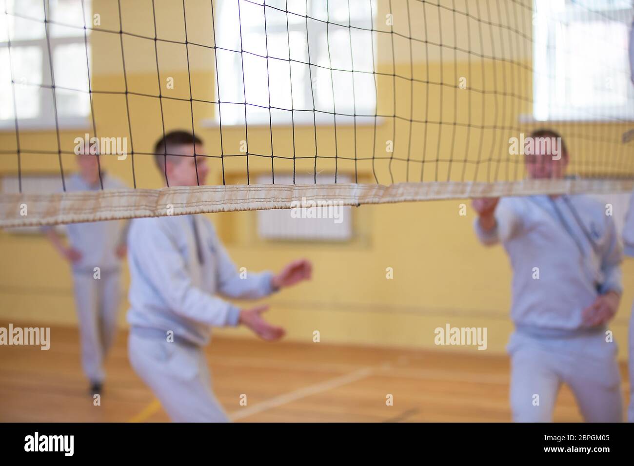 Volleyball net on the background of blurry players Stock Photo