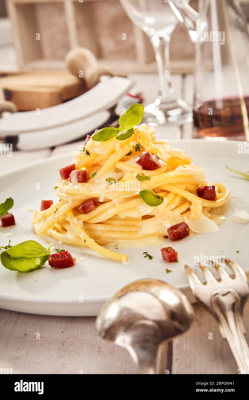 Food styling concept with Italian spaghetti with diced grilled ham or