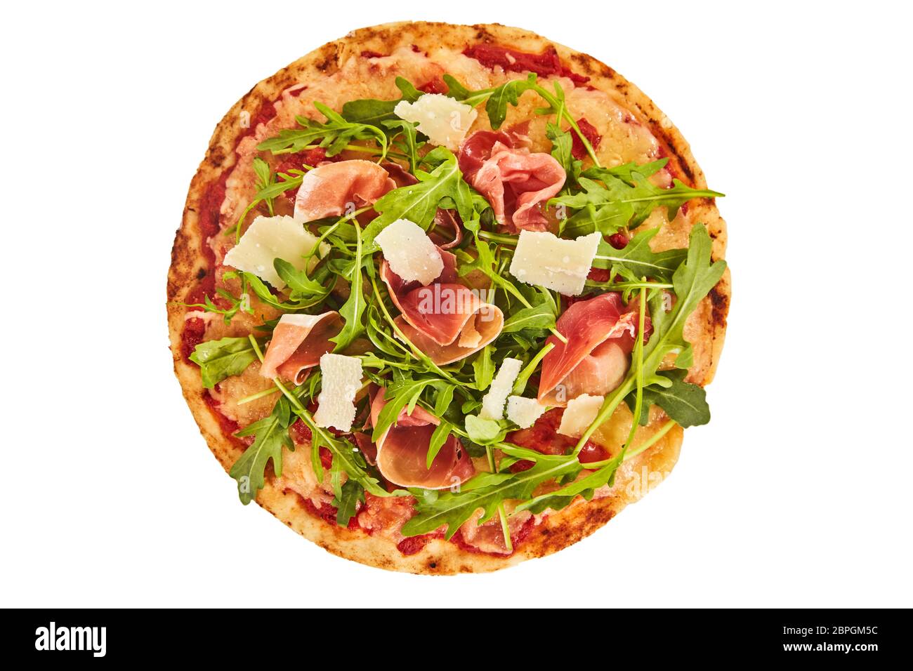 Whole oven baked Italian prosciutto and rocket pizza with a garnish of