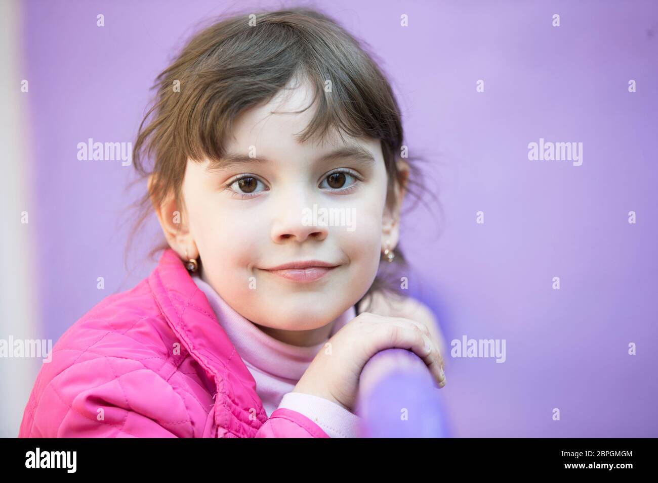 Six year old girl looking at the camera. Portrait of a little
