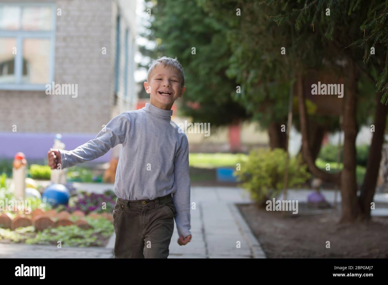 Belarus, the city of Goml, April 26, 2019. Photosession in kindergarten.Funny happy child is walking down the street. A six-year-old boy is in a wonde Stock Photo