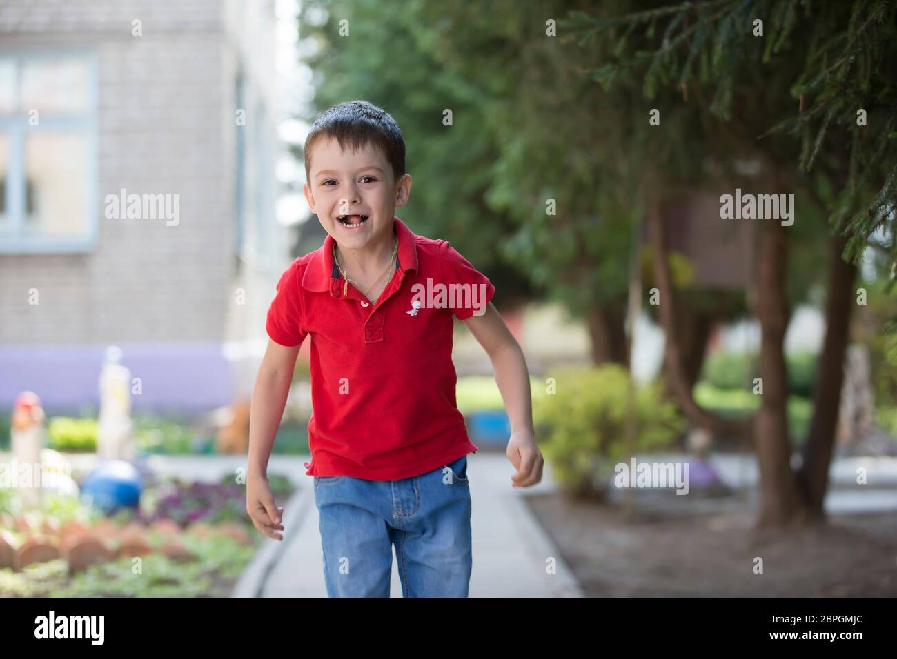Belarus, the city of Goml, April 26, 2019.  Photosession in kindergarten.Funny preschooler child is walking down the street. Six year old cheerful boy Stock Photo