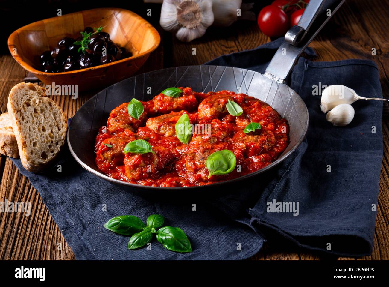Baked mini meatballs in tomato sauce with basil Stock Photo Alamy