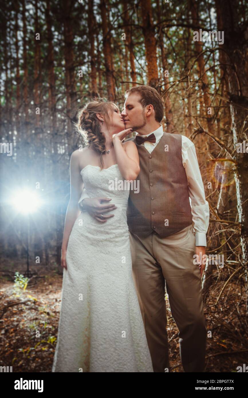bride and groom in the forest of firs Stock Photo - Alamy