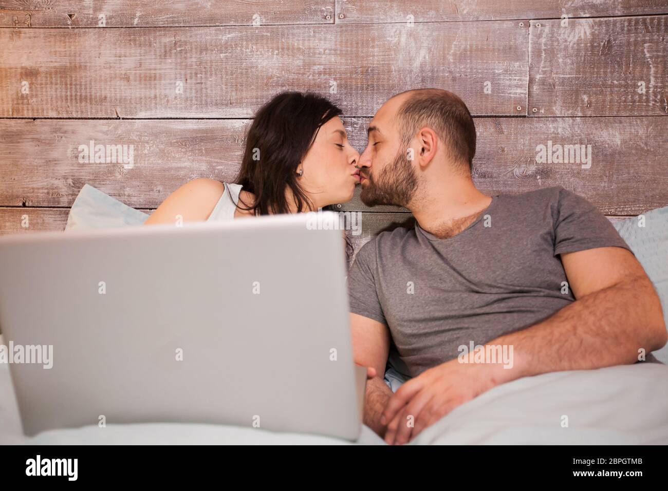 Romantic couple kissing in bed hi-res stock photography and images - Alamy