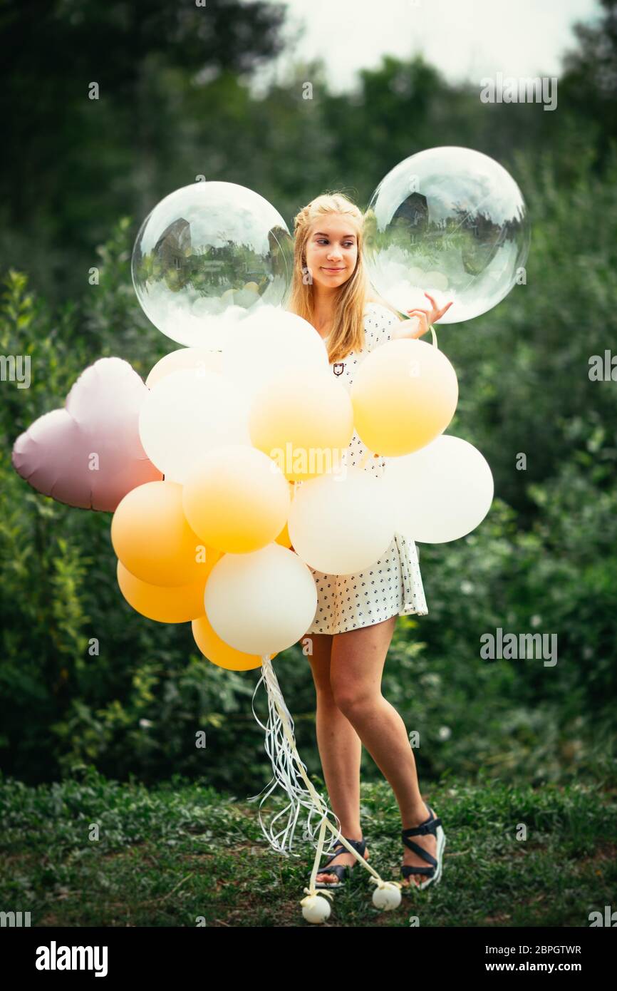 young girl with balloons on nature background Stock Photo - Alamy