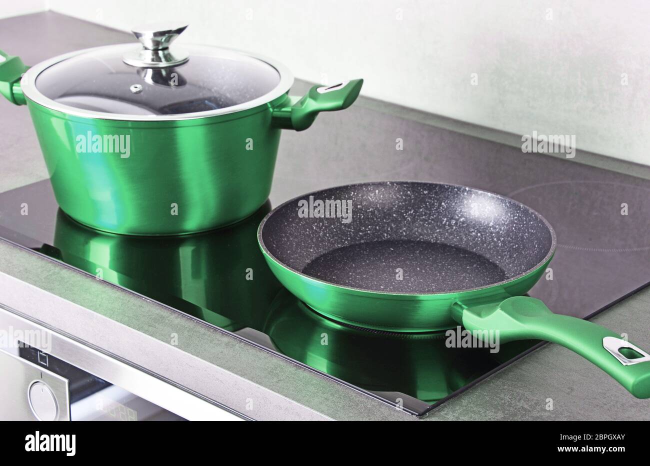 Frying pan and steel pot on modern induction cooktop Stock Photo Alamy