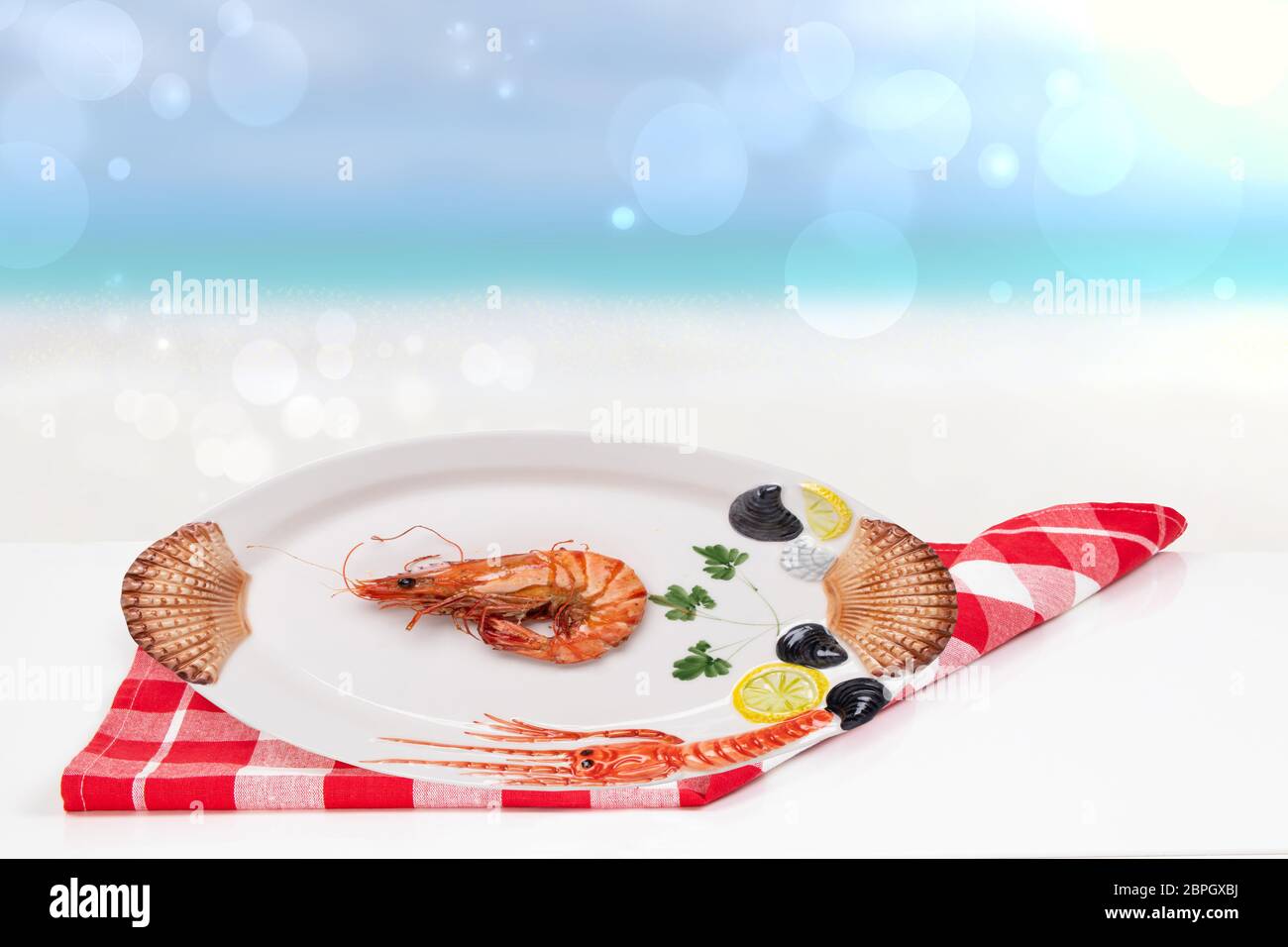 Table top on seafood background. A Fresh grilled big prawn tiger or shrimps  on a white table in front of abstract blurred tropical beach with blue sky  Stock Photo - Alamy