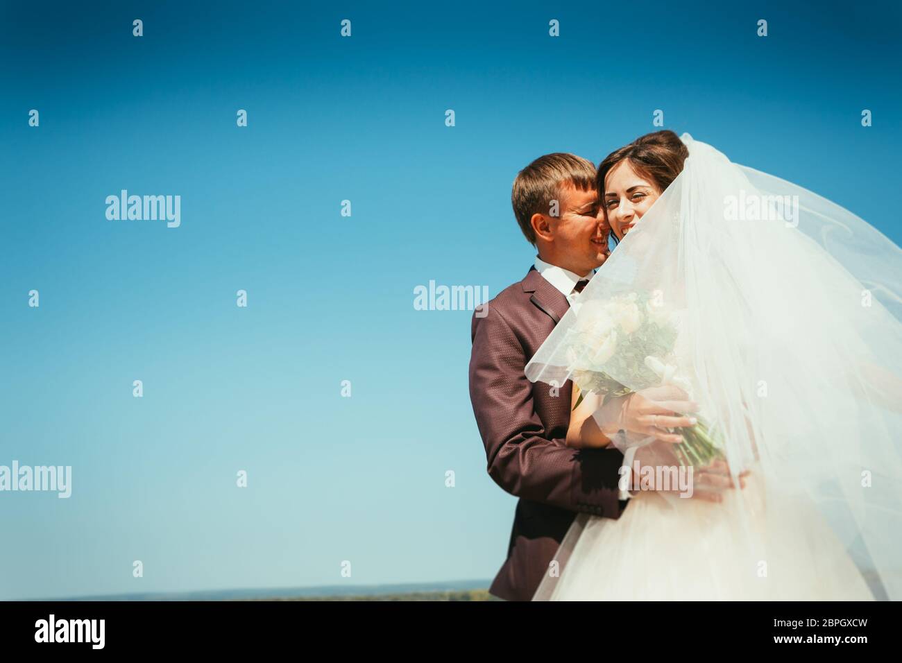 young bride and groom couple on the sky background Stock Photo - Alamy