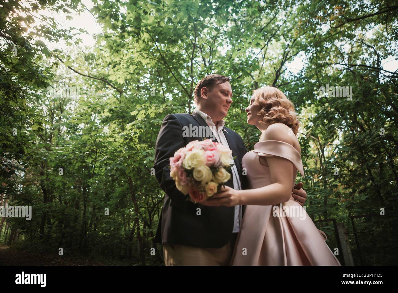 bride and groom dancing in the forest background and sunlight Stock ...