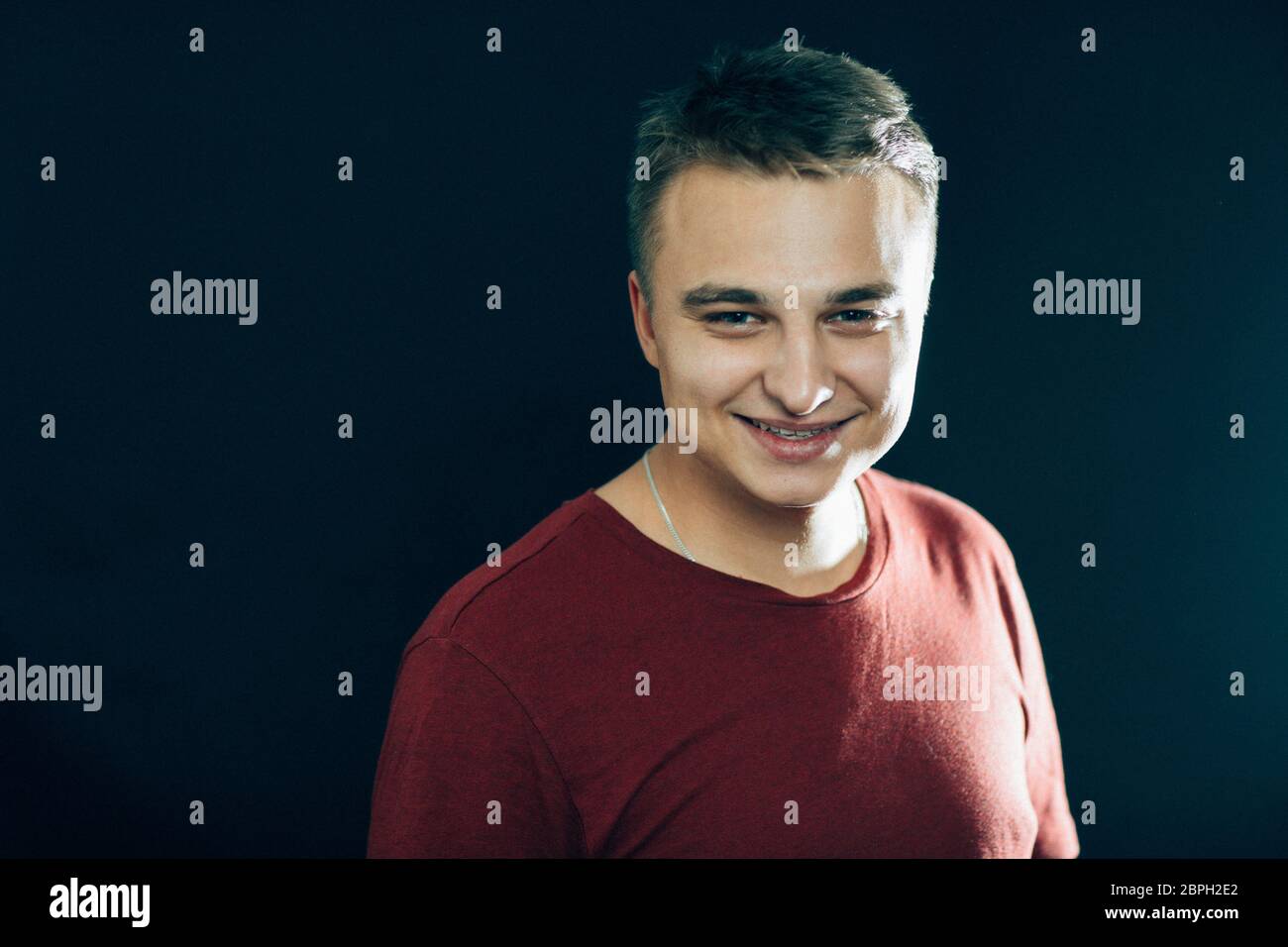 portrait of a young man on a dark background Stock Photo - Alamy