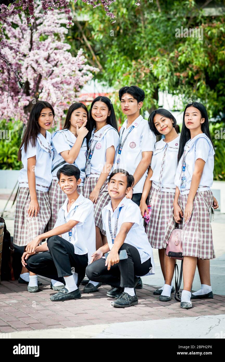 Playful Filipino school children pose in a park in Angeles City, The