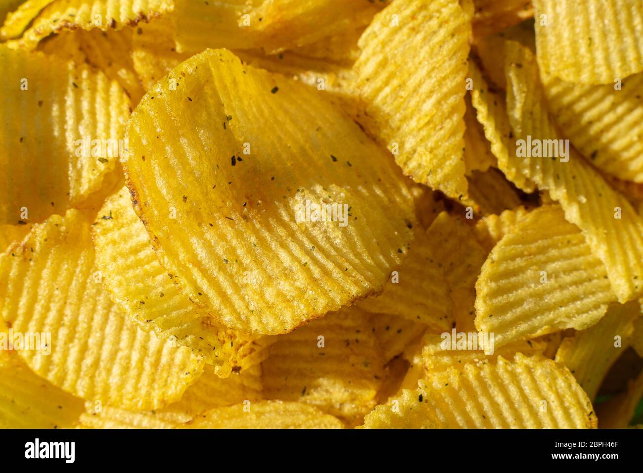 crispy potato chips close-up. edible background. corrugated chips structure Stock Photo