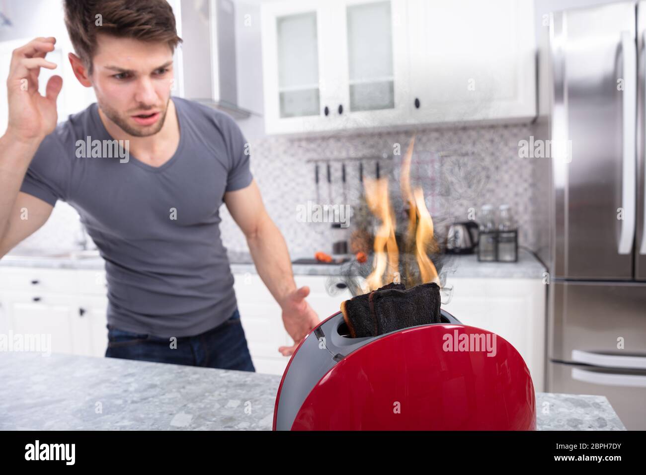 Portrait Of Scary Man Looking At Slice Of Burn Coming Out Of Toaster