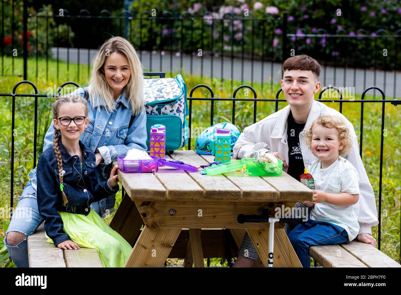 Emma Coleman with Cameron Mills, Lila-Grace Coleman, aged eight and Remy Coleman, aged three, enjoying a picnic at Botanic Gardens in Belfast. The Northern Ireland Executive announced a series of lockdown relaxations on Monday, which included groups of up to six people who do not share a household being allowed to meet outdoors. Stock Photo