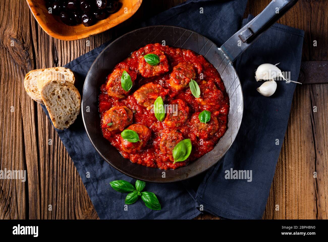 Baked mini meatballs in tomato sauce with basil Stock Photo Alamy