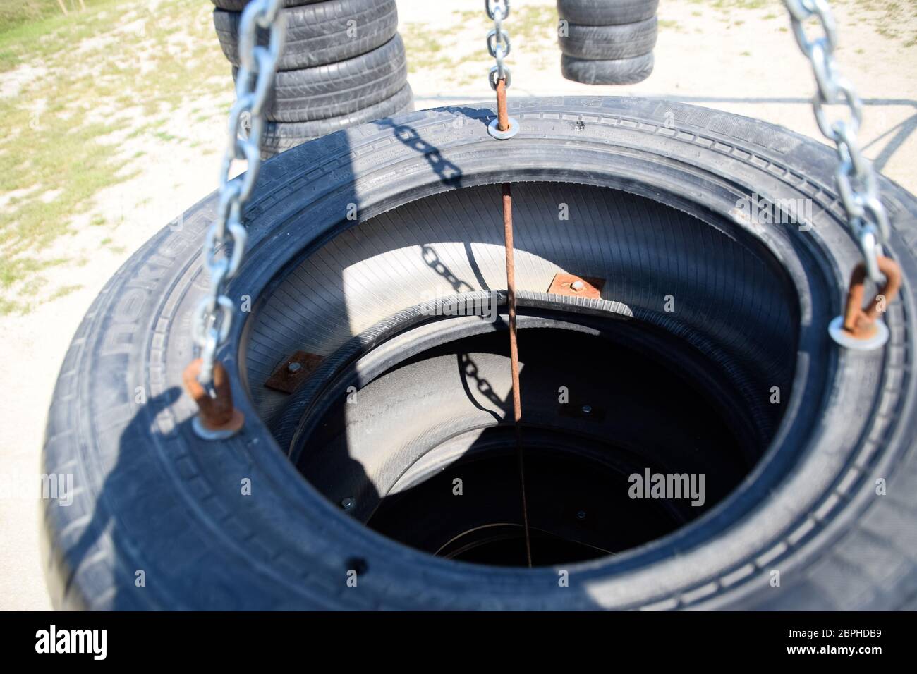 Homemade punching bag made from old car tires fastened with steel  reinforcement. punching bag Stock Photo - Alamy