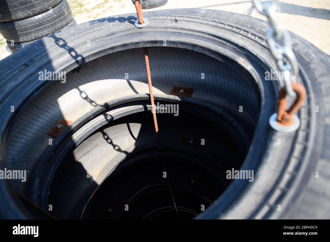Homemade punching bag made from old car tires fastened with steel