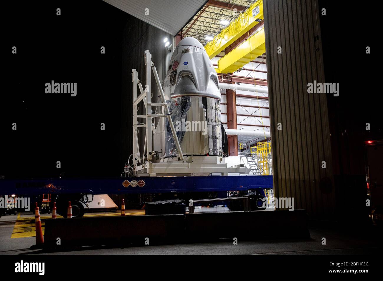 The SpaceX Crew Dragon spacecraft arrives at Launch Complex 39A at NASA's Kennedy Space Center in Florida, transported from the company's processing facility at Cape Canaveral Air Force Station on Friday, May 15, 2020, in preparation for the Demo-2 flight test with NASA astronauts Robert Behnken and Douglas Hurley to the International Space Station for NASA's Commercial Crew Program. Crew Dragon will carry Behnken and Hurley atop a SpaceX Falcon 9 rocket, returning crew launches to the space station from U.S. soil for the first time since the Space Shuttle Program ended in 2011. NASA Photo by Stock Photo