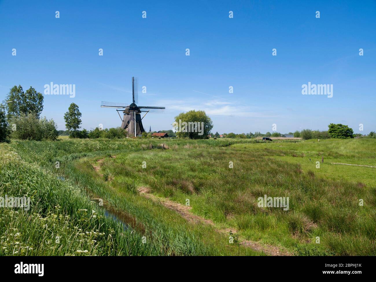 Windmill the Oostzijdse Molen on the river Gein near the Dutch village ...