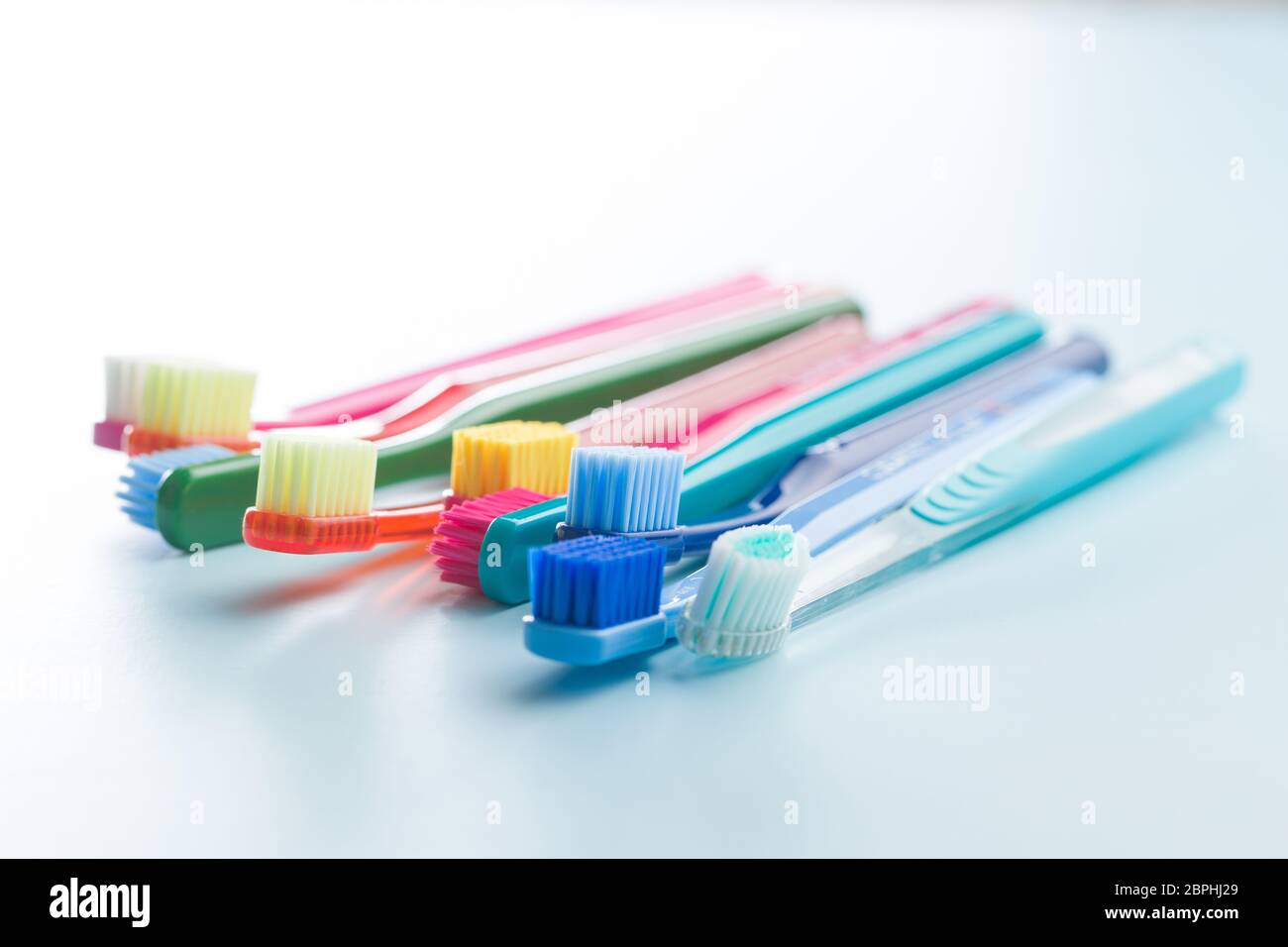 Colorful toothbrushes on blue background Stock Photo - Alamy