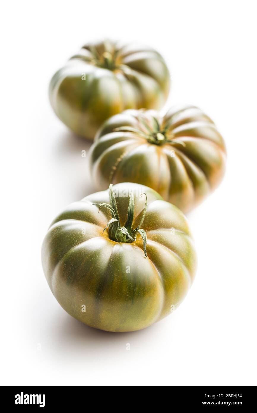 Dark brandywine tomatoes isolated on white background. Stock Photo