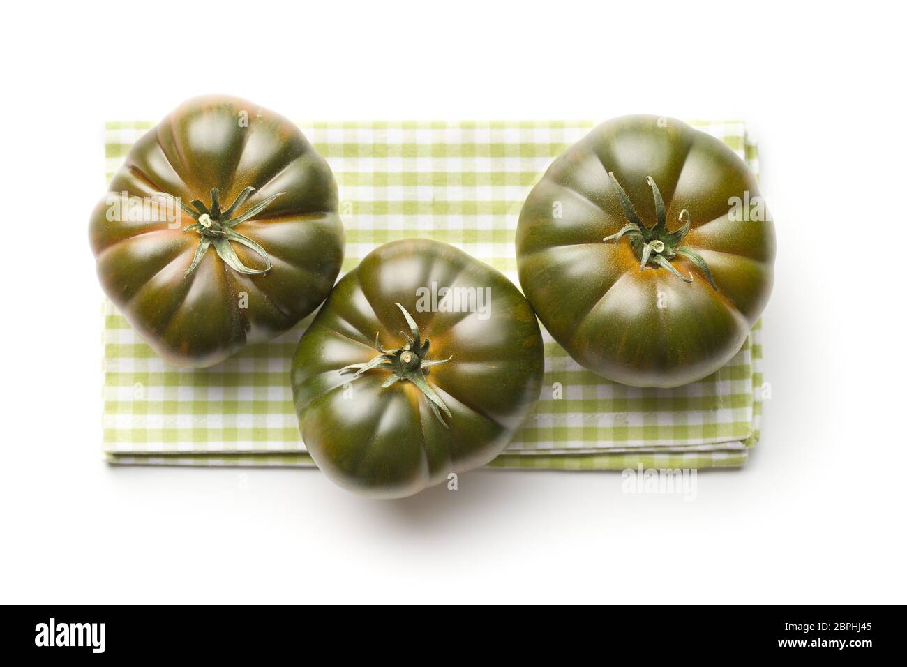 Dark brandywine tomatoes isolated on white background. Stock Photo