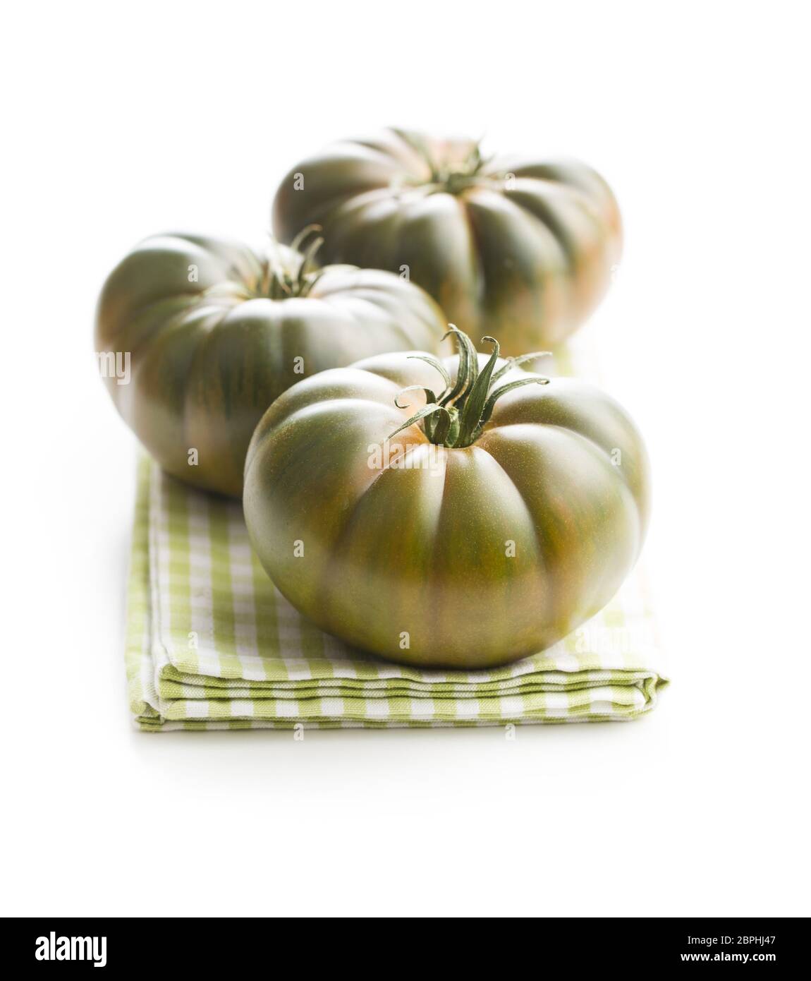 Dark brandywine tomatoes isolated on white background. Stock Photo