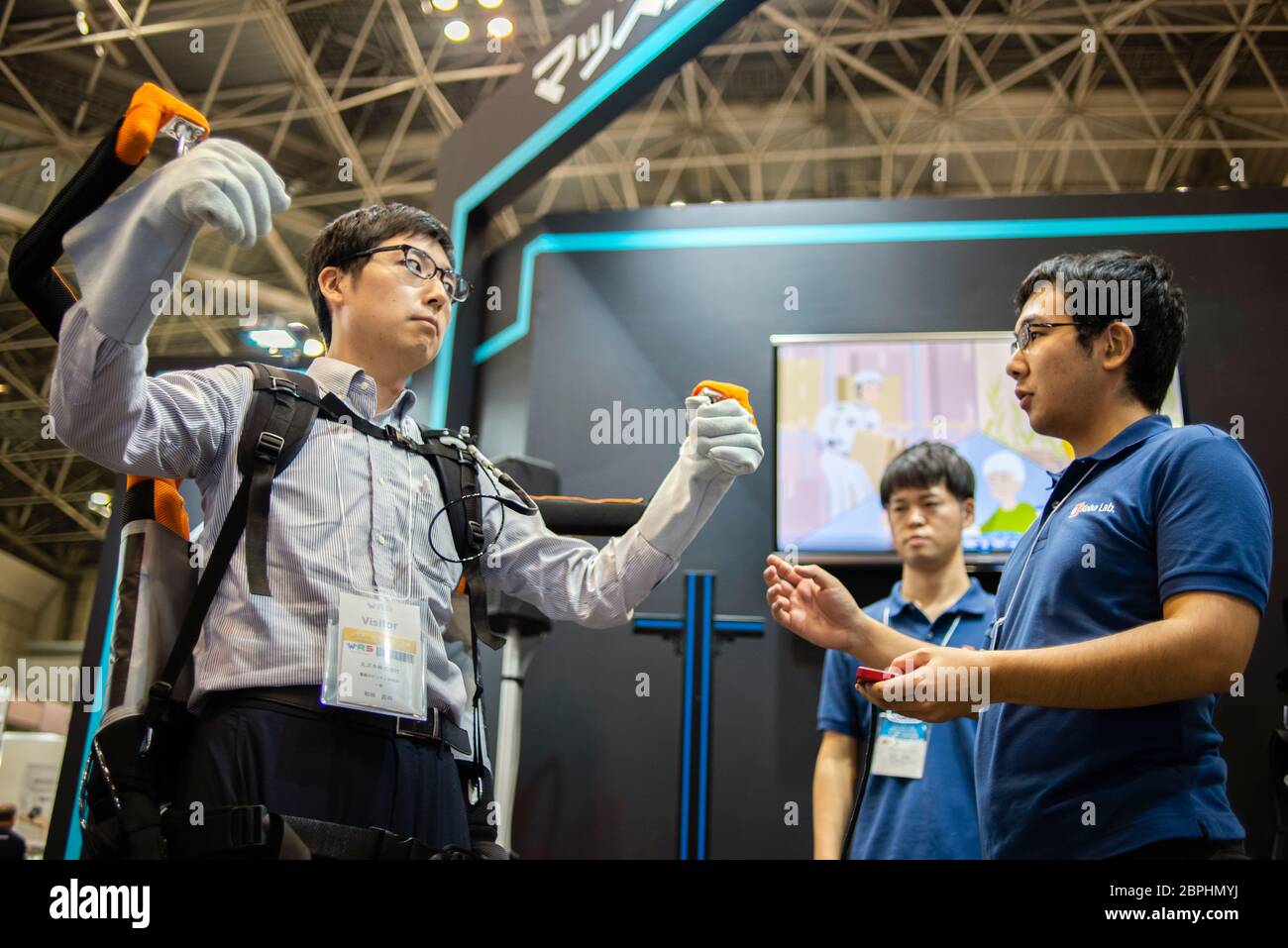 A visitor tries an exoskeleton robot suit during the Japan Robot Week