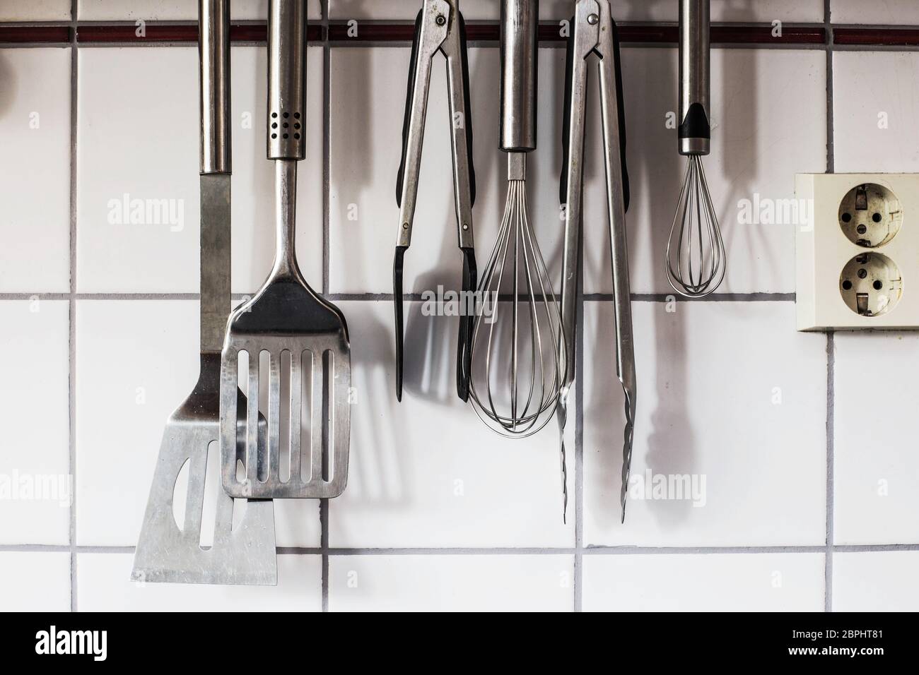 The kitchenware hanging on the wall in the kitchen objects Stock Photo