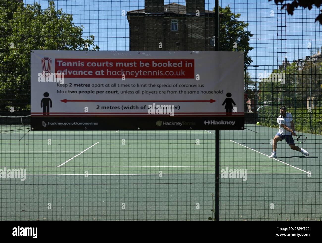 A man playing tennis in the hot weather, in London Fields park, east London,  after the introduction of measures to bring the country out of lockdown  Stock Photo - Alamy