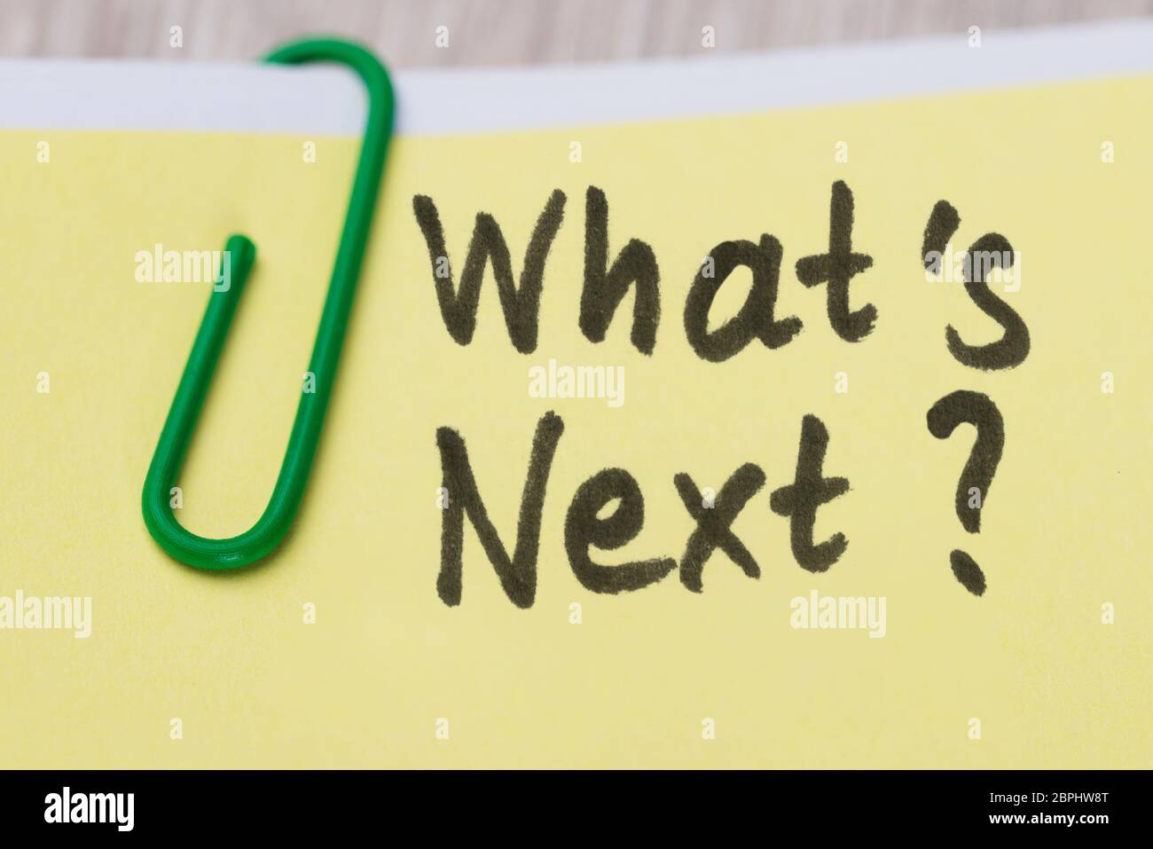 Closeup Of What's Next Text On Yellow Adhesive Notes With Green Paper