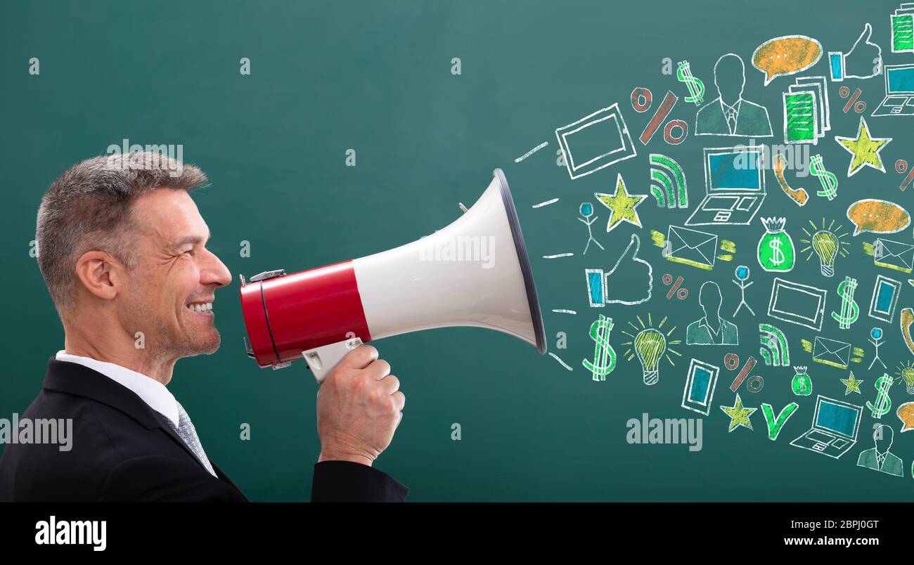 Smiling Man With Megaphone Different Icons For Digital Marketing Concept On Greenboard Stock Photo