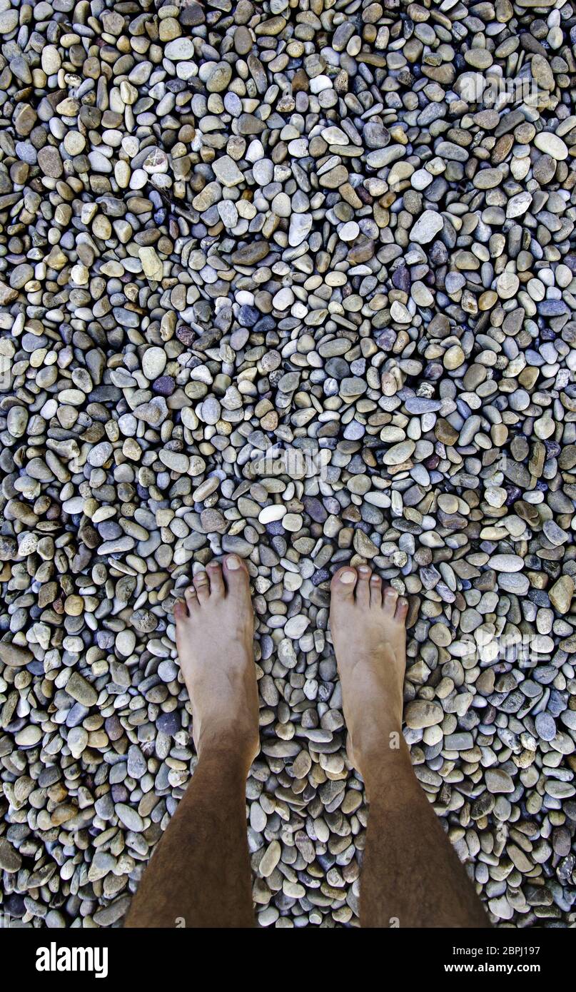 Barefoot feet on a stones, detail of relaxation, spa and zen Stock