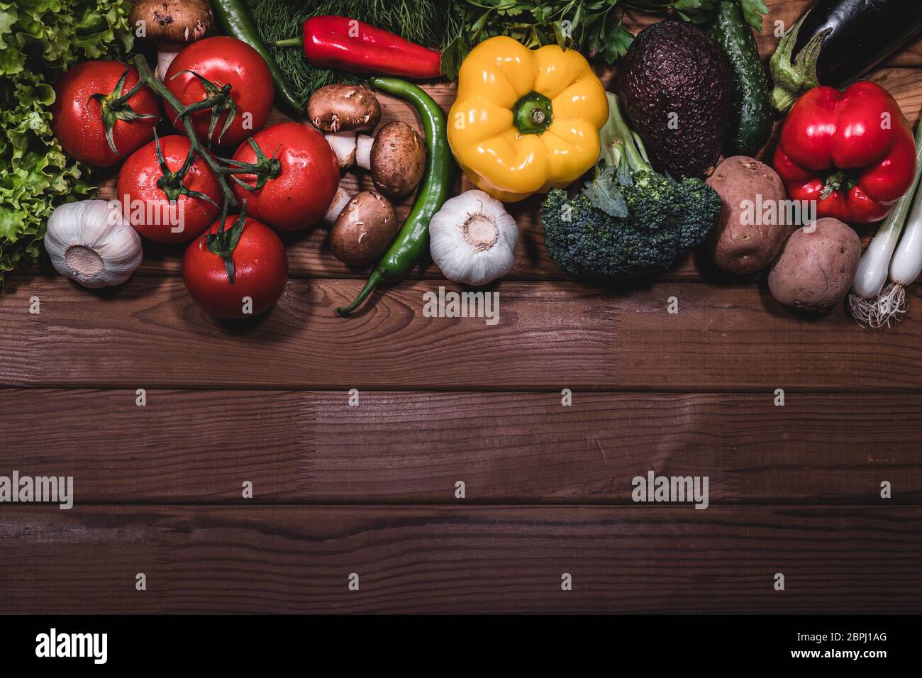 Copy space flat lay composition with fresh vegetables products on dark ...