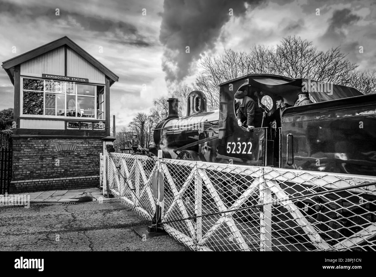 Restored steam locomotive BR 52322 pictured on the level crossing at Ramsbottom on the East Lancashire railway. steam train Stock Photo