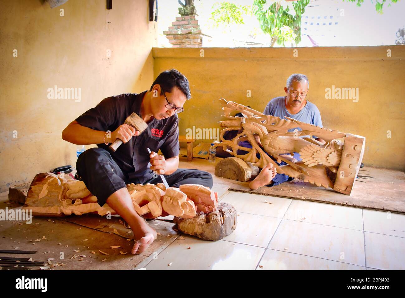 A mans is making wooden crafts in Bali Island, Indonesia Stock Photo