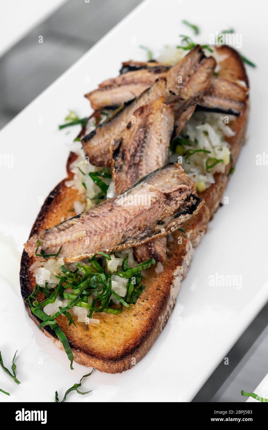 Portuguese tiborna open toast sandwich tapas with sardine and onion