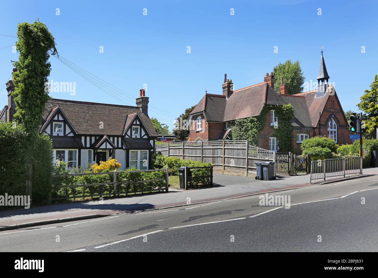 A traditional Englisg timber cottage stands next to the Victorian school bulding of Gresham Primary School in the village of Sanderstead, Surrey. Stock Photo