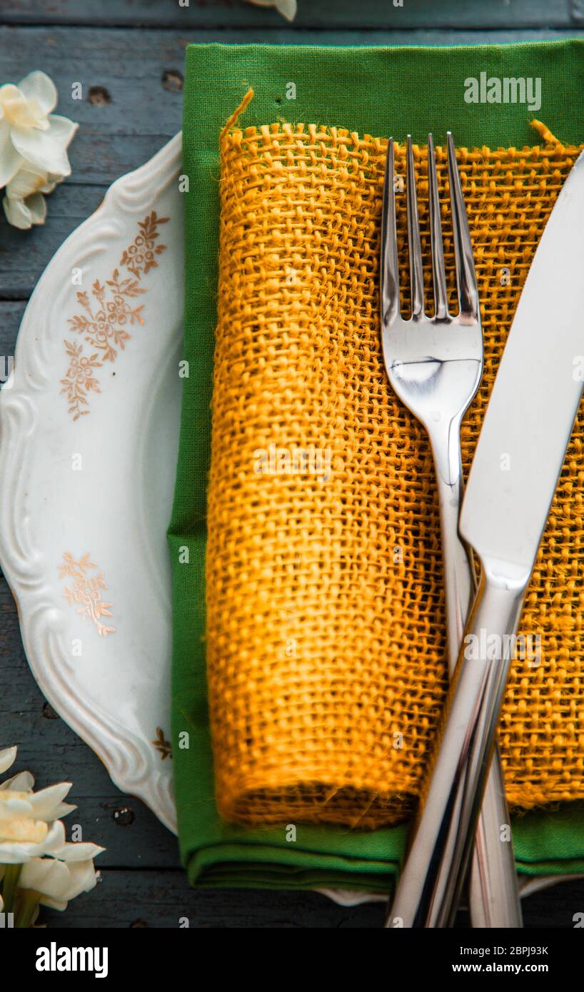 Spring table setting. Narcissus flower. Fork on Easter table. Holiday table setting Stock Photo