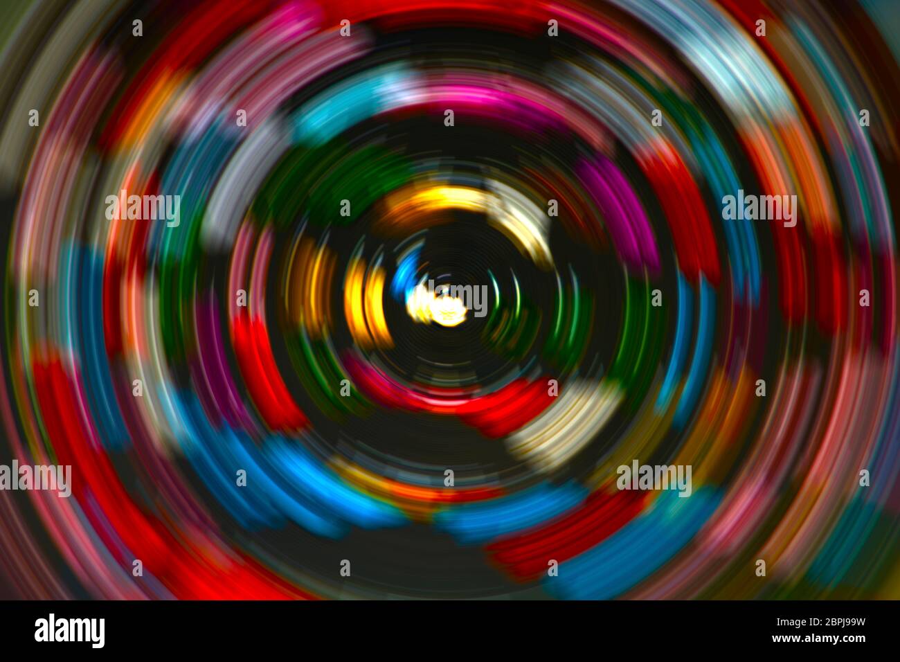 Radial motion blur background image with circles of alternating colors with focal point. Stock Photo