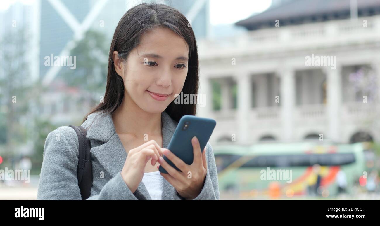 Business woman use of smart phone in Hong Kong Stock Photo - Alamy
