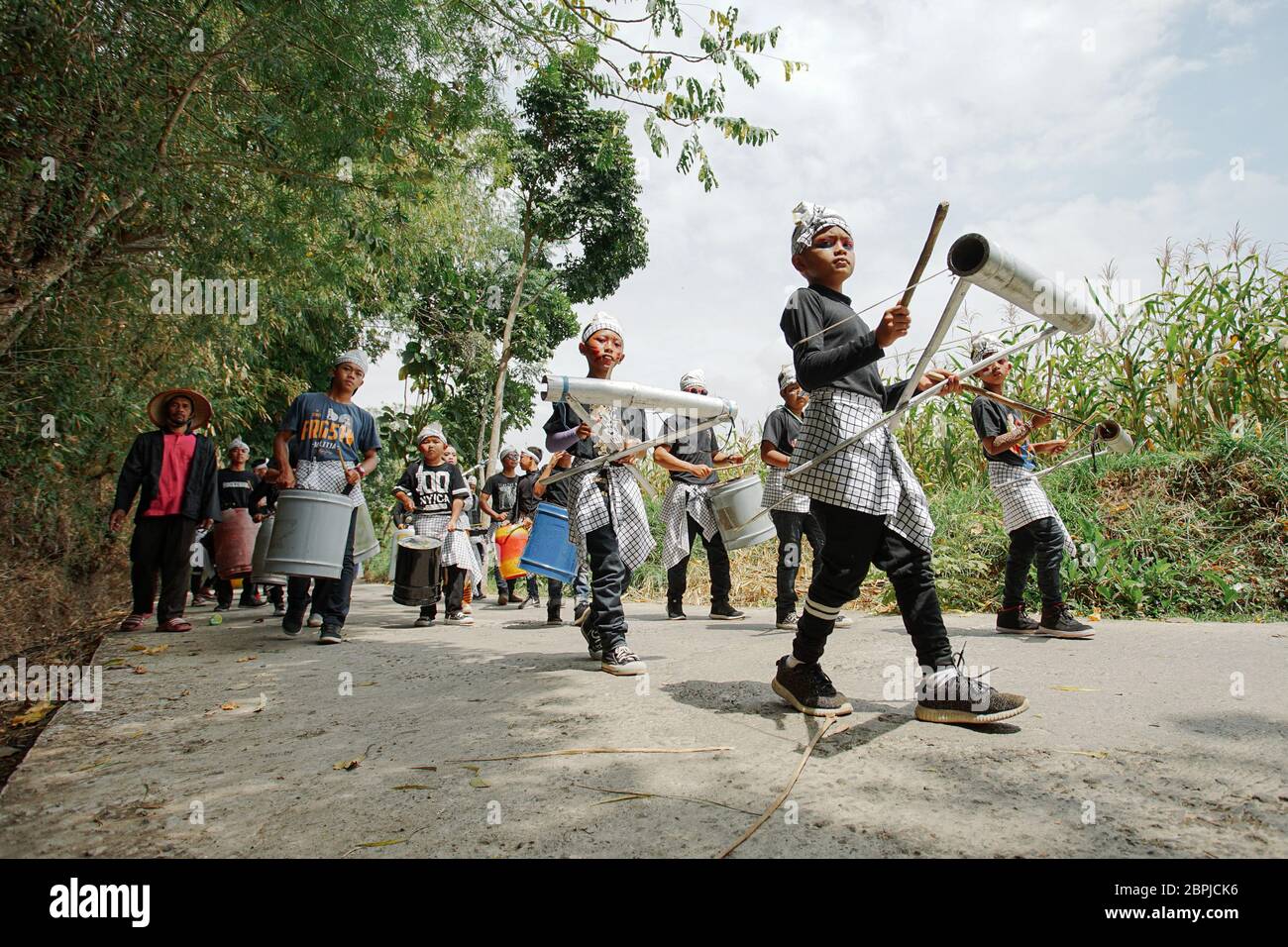 Kids performing Drumblek, contemporary music instruments from unused tools at Badran village, Central Java, Indonesia Stock Photo